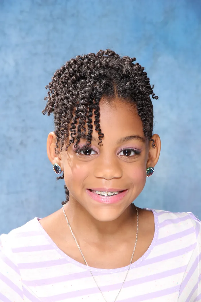 Client smiling with a cornrow and twist combination style