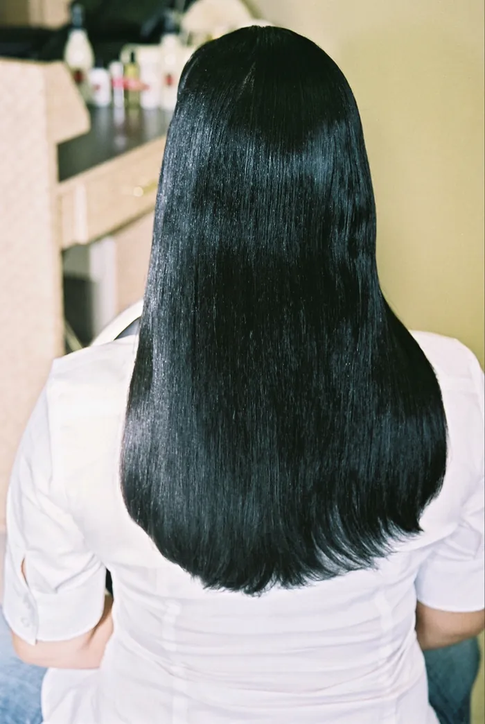 Long straight hair falling down a client's back