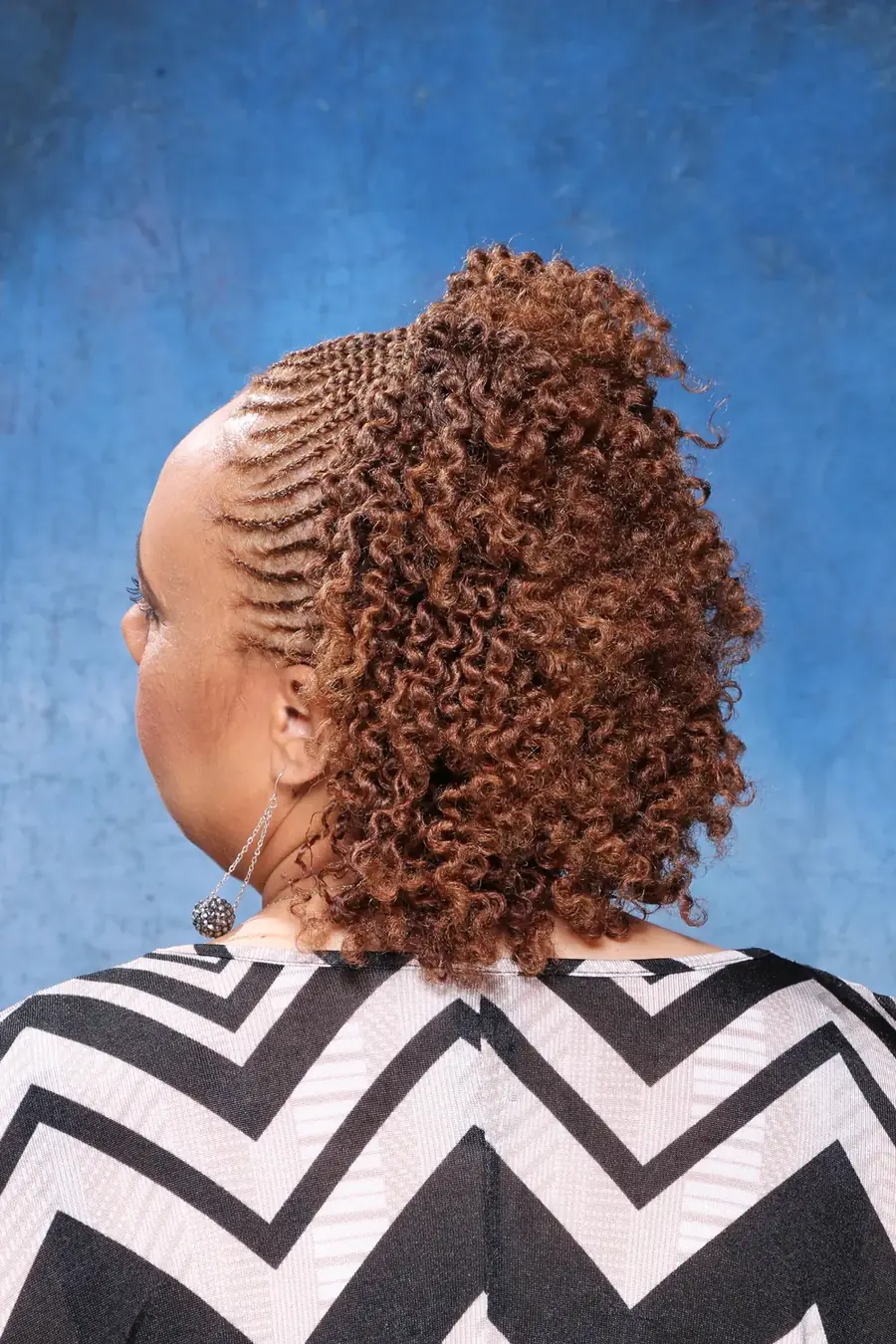 Back view of defined curls with a flat-twist detail at the crown